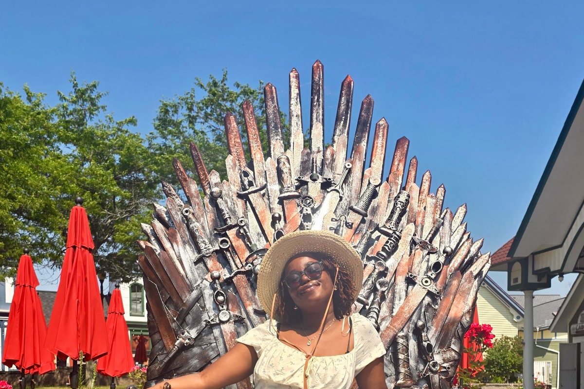 Cynthia sitting on an iron throne sculpture